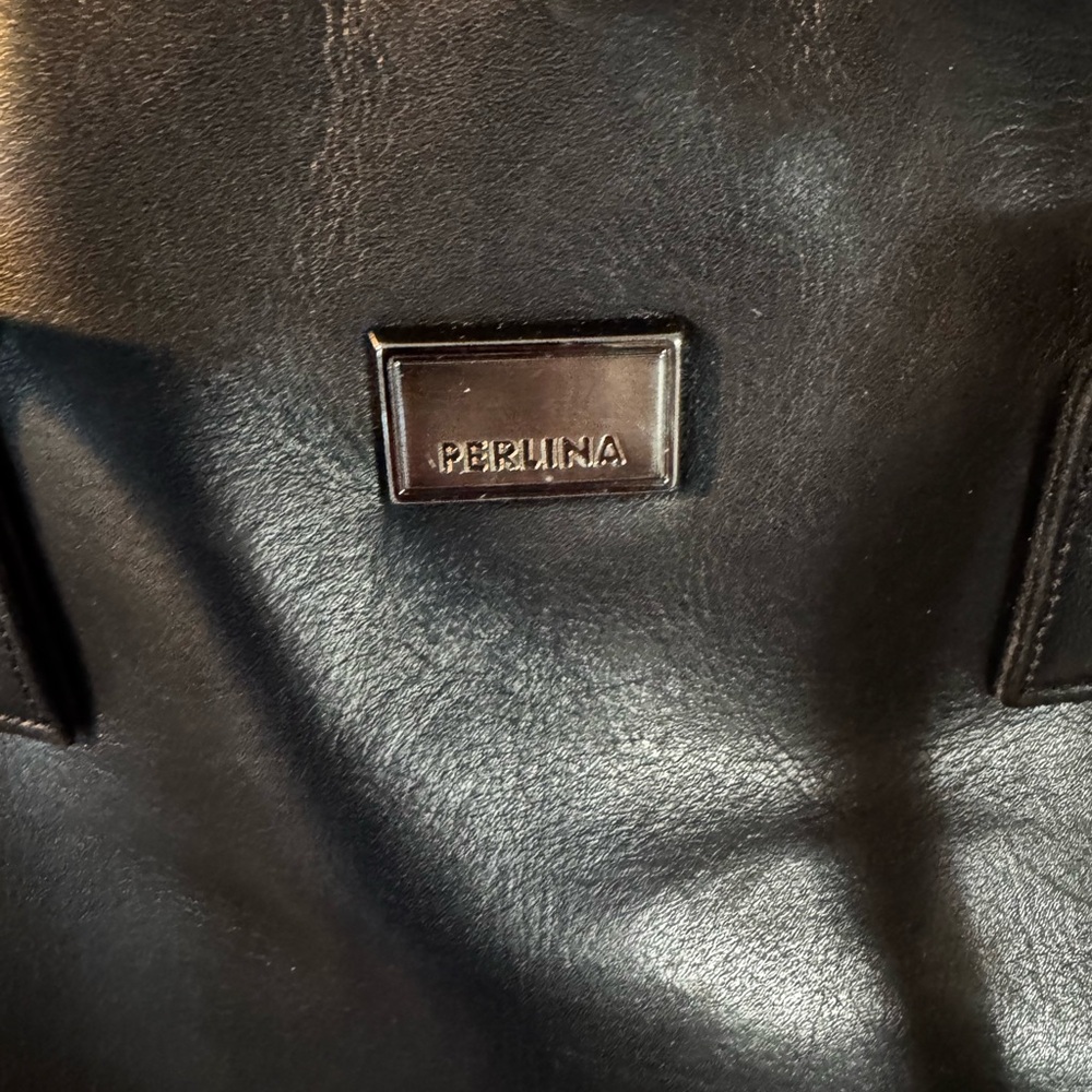 Perlina women’s shoulder black leather purse.
